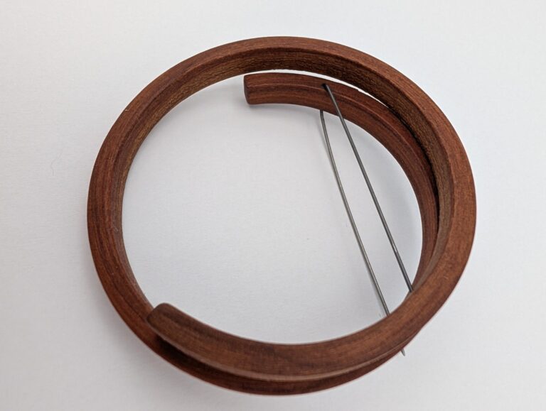 The Interval Brooch by Gustav Reyes.