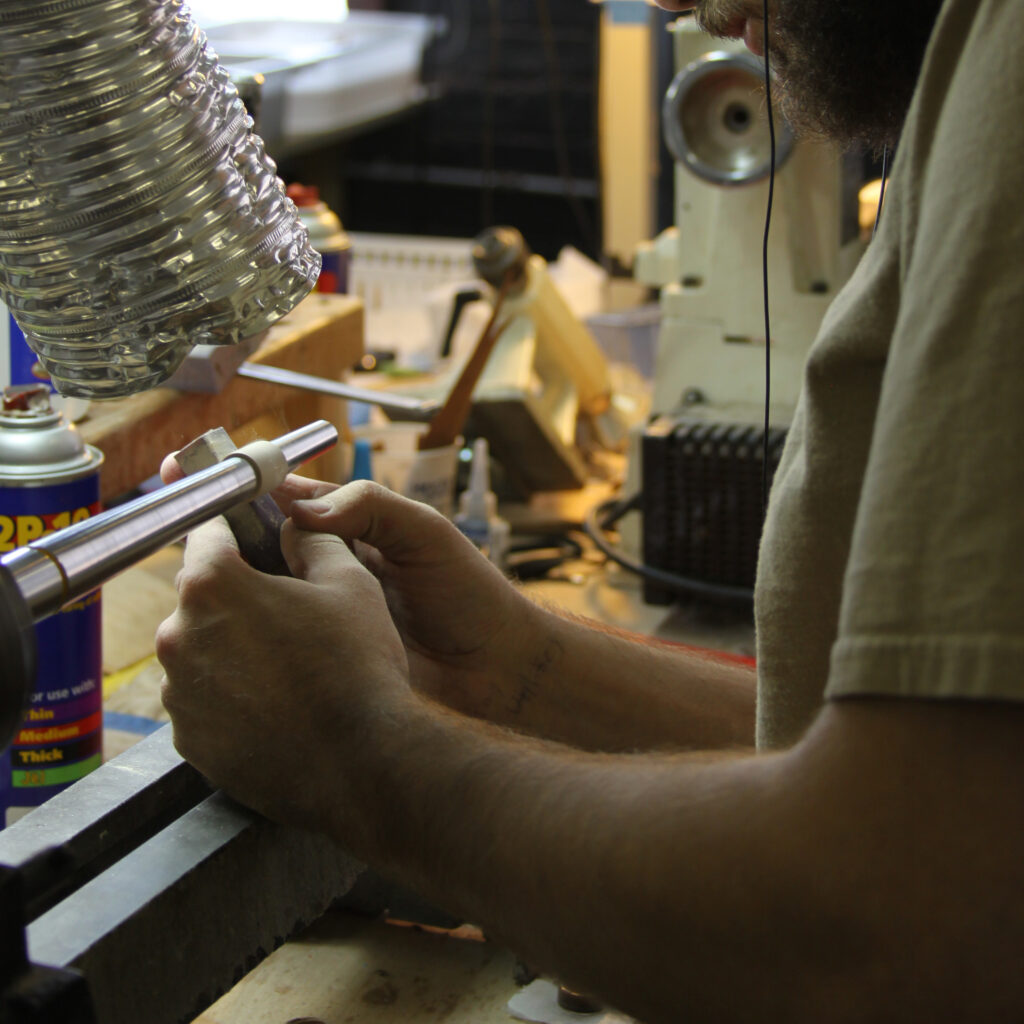 A wood ring being sanded at the lathe in the Simply Wood Rings studio.
