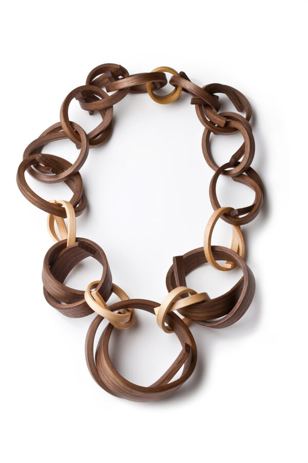 Tie Me Not, a Gustav Reyes neckpiece using repeated linked bent-wood forms.