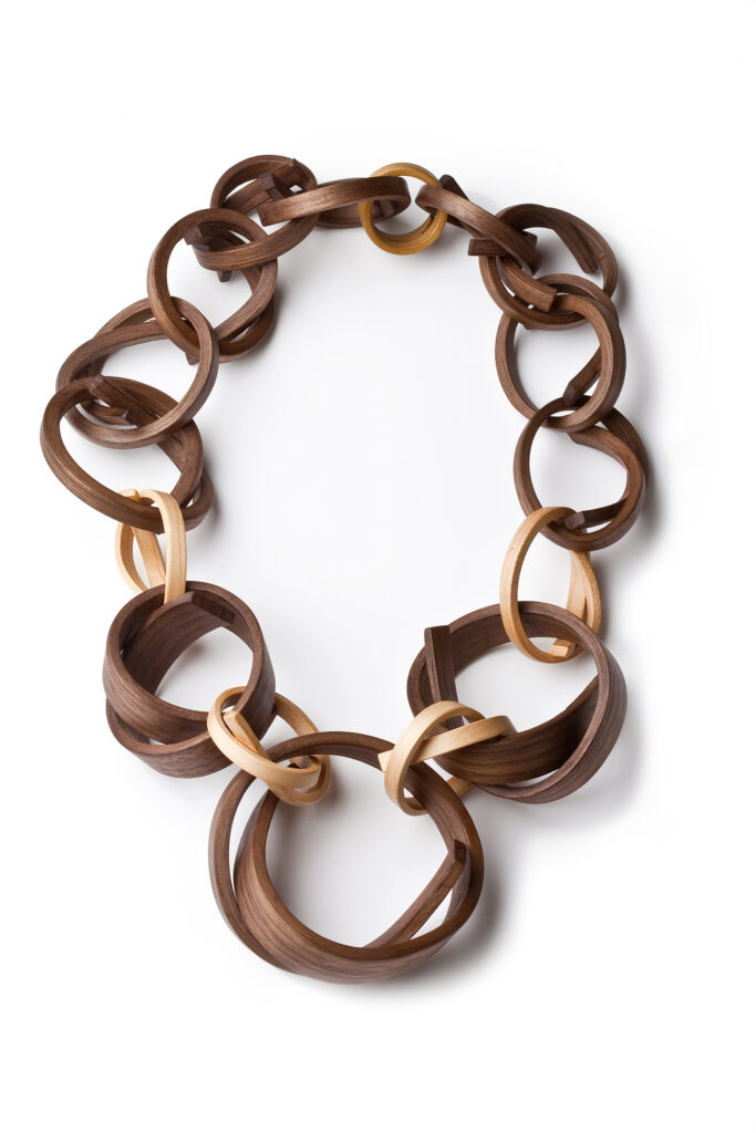 Tie Me Not, a Gustav Reyes neckpiece using repeated linked bent-wood forms.